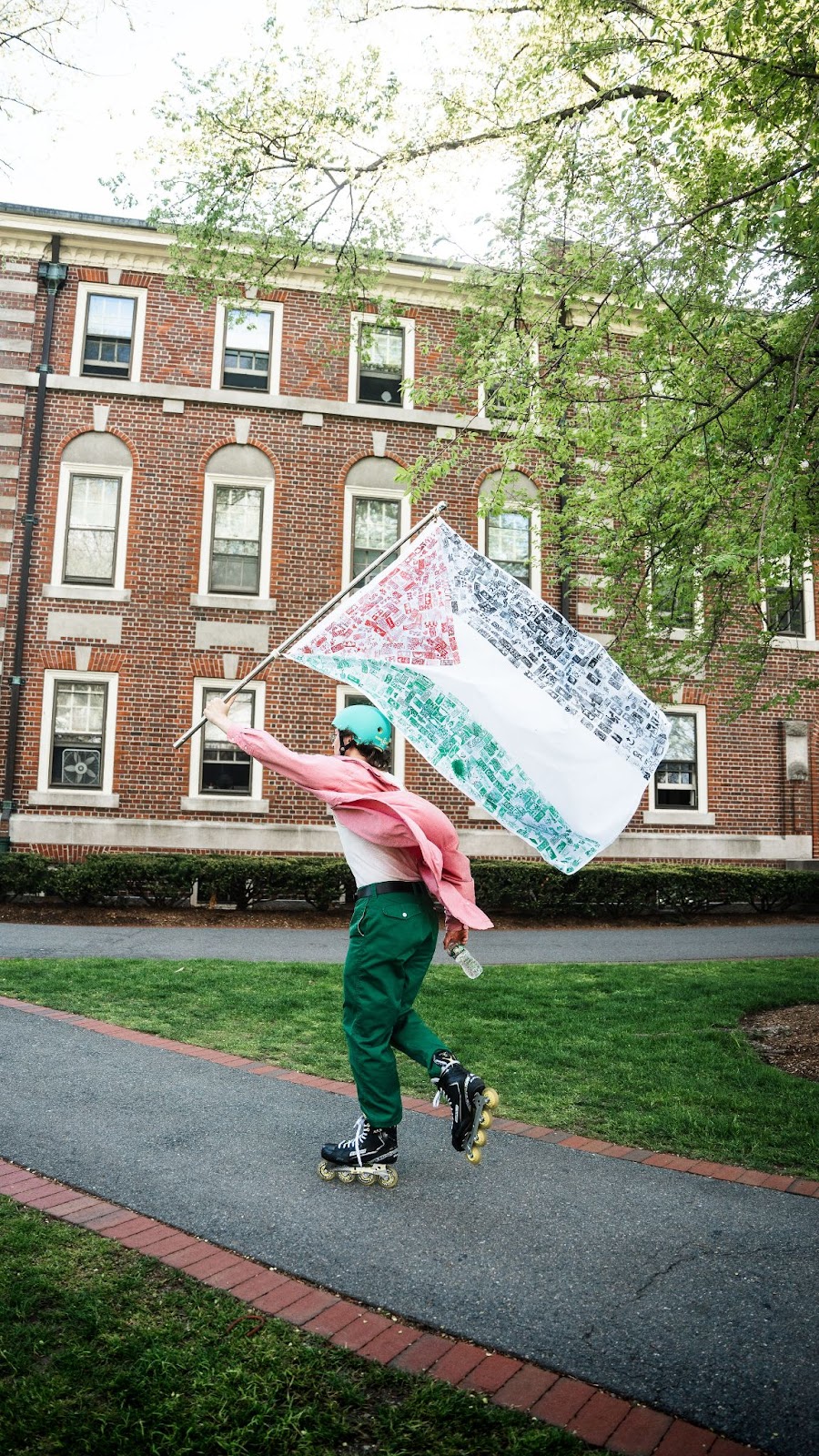 A student rollerblading around campus with a pro-palestine flag.